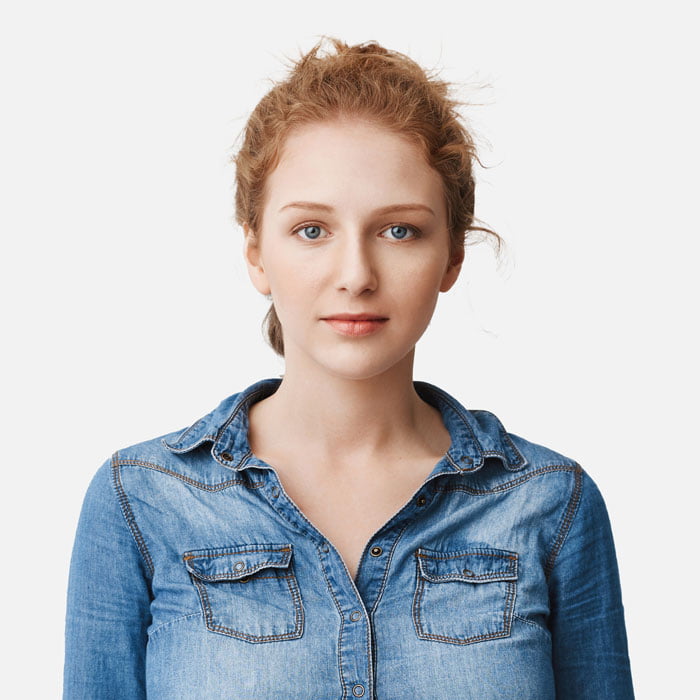 A young woman wearing a denim shirt.