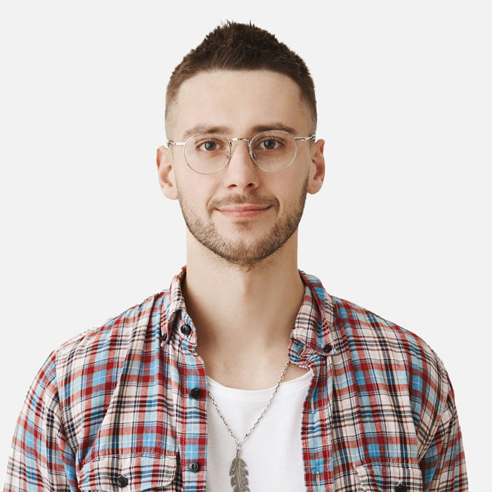 A young man wearing glasses and a plaid shirt.